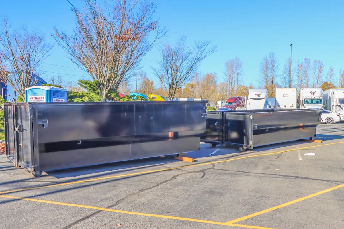 Professional dumpster rental service with roll-off container on residential driveway in Peoria